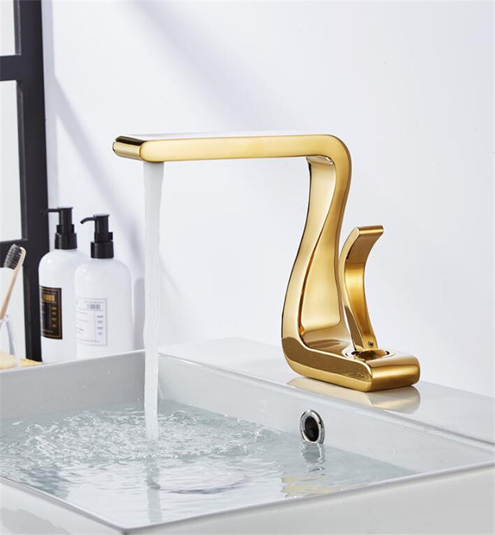 Robinet lavabo salle de bain mitigeur design incurvé en laiton doré avec eau qui coule. Parfait pour ajouter une touche de luxe à votre salle de bain.